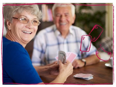 Older man and woman playing cards 