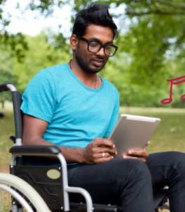 Man in a wheelchair using an iPad